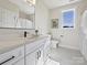 Well-lit bathroom featuring a white vanity with a black faucet and a window with views to the outside at 1160 Springlake Rd, York, SC 29745