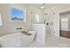 Bright primary bathroom features a soaking tub, a large glass shower, and a view of the outdoors at 1160 Springlake Rd, York, SC 29745