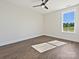 Bright bedroom featuring hardwood floors, natural light streaming through a large window, and neutral wall colors at 1160 Springlake Rd, York, SC 29745