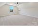 Spacious bedroom with plush carpeting, a ceiling fan, and a window offering views of the outdoors at 1160 Springlake Rd, York, SC 29745