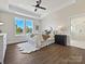 Bright bedroom featuring wood-look floors, tray ceilings, plush rug, and a view of the outdoors at 1160 Springlake Rd, York, SC 29745
