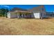 Exterior view of home with covered patio and expansive yard ready for customization at 1160 Springlake Rd, York, SC 29745