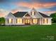 Charming white farmhouse with wood accents, covered front porch, and manicured lawn at 1160 Springlake Rd, York, SC 29745