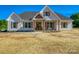 Beautiful home exterior features wood accents, a covered porch, and manicured landscaping at 1160 Springlake Rd, York, SC 29745