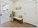 Inviting mudroom with bench seating, a decorative plant, and an adjacent laundry room for added convenience at 1160 Springlake Rd, York, SC 29745