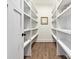 Walk-in pantry featuring wood-look flooring, ample shelving for optimal organization and stylish decor at 1160 Springlake Rd, York, SC 29745