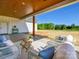 Covered patio with outdoor seating offers scenic views of the expansive backyard and blue sky at 1160 Springlake Rd, York, SC 29745