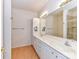 Bathroom featuring dual sinks, a large mirror, and white cabinetry at 11705 Silverado Ln, Charlotte, NC 28277