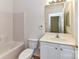 Bright bathroom features a combined shower and bathtub with crisp white tile, vanity, and modern fixtures at 11705 Silverado Ln, Charlotte, NC 28277