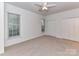 Large carpeted bedroom features multiple windows and a double door closet at 11705 Silverado Ln, Charlotte, NC 28277