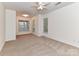 Bright bedroom features neutral carpet, multiple windows, and a ceiling fan at 11705 Silverado Ln, Charlotte, NC 28277