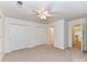 Large bedroom offers neutral carpet, a ceiling fan, closet with double doors and access to another room at 11705 Silverado Ln, Charlotte, NC 28277