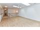 Bright, upper-level room features hardwood floors, a ceiling fan, and a chandelier near the stairs at 11705 Silverado Ln, Charlotte, NC 28277