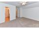 Bedroom with an ensuite bathroom and a ceiling fan with overhead lighting at 11705 Silverado Ln, Charlotte, NC 28277