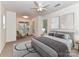 Well-lit primary bedroom featuring a cozy seating area, ceiling fan, and serene decor at 11705 Silverado Ln, Charlotte, NC 28277