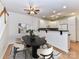 Dining room featuring a large dining table, modern decor, and open access to the kitchen at 11705 Silverado Ln, Charlotte, NC 28277