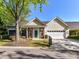 Inviting single-story home with well-maintained lawn, brick accents, front door, and attached garage at 11705 Silverado Ln, Charlotte, NC 28277