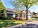 Picture of house showing the garage, green door, shutters, and well maintained landscaping at 11705 Silverado Ln, Charlotte, NC 28277
