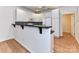 Well-lit kitchen with white cabinets, black countertops, breakfast bar, and modern appliances at 11705 Silverado Ln, Charlotte, NC 28277