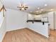 Bright kitchen with white cabinets, a bar area, and an open design that flows into the dining and living spaces at 11705 Silverado Ln, Charlotte, NC 28277