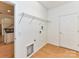 Bright laundry room featuring wood-look flooring, wire shelving, and white walls at 11705 Silverado Ln, Charlotte, NC 28277