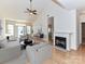 Bright living room featuring a fireplace, hardwood floors, vaulted ceiling, and neutral color palette at 11705 Silverado Ln, Charlotte, NC 28277
