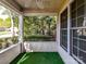 Relaxing screened porch with green carpeting and views of the wooded exterior at 11705 Silverado Ln, Charlotte, NC 28277