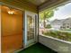 Inviting porch with sliding glass door to carpeted room and pleasant view of well-maintained neighborhood at 11705 Silverado Ln, Charlotte, NC 28277