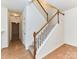 Bright foyer with staircase featuring carpeted steps, white risers, and a natural wood railing at 11705 Silverado Ln, Charlotte, NC 28277