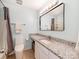 Bright bathroom featuring granite countertops, modern vanity, and updated fixtures at 1217 Green Oaks Ln # K, Charlotte, NC 28205