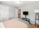 Bedroom featuring a bed, TV and a doorway leading to the hallway at 1217 Green Oaks Ln # K, Charlotte, NC 28205