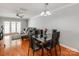 Bright dining area with a glass table, leading to a living room with a ceiling fan at 1217 Green Oaks Ln # K, Charlotte, NC 28205