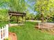 Open air wooden gazebo with concrete flooring on grassy lot at 1217 Green Oaks Ln # K, Charlotte, NC 28205