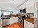 Modern kitchen with stainless steel appliances, granite countertops, and a view to the dining area at 1217 Green Oaks Ln # K, Charlotte, NC 28205