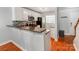 Modern kitchen featuring white cabinets, granite countertops, and stainless steel appliances at 1217 Green Oaks Ln # K, Charlotte, NC 28205
