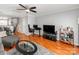 Open living area with hardwood floors, ceiling fan, and access to the dining and kitchen areas at 1217 Green Oaks Ln # K, Charlotte, NC 28205