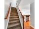 Carpeted staircase leading to an open floor plan with wood floors and stainless steel appliances at 1217 Green Oaks Ln # K, Charlotte, NC 28205