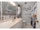 Neutral bathroom with patterned wallpaper, framed mirror, white cabinets and shower with curtain at 1218 Donna Dr, Shelby, NC 28152