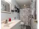 Clean bathroom with floral shower curtain, white vanity with chrome faucet, and decorative mirror at 1218 Donna Dr, Shelby, NC 28152