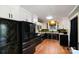Updated kitchen features granite countertops, white cabinets, black stainless appliances, and hardwood floors at 1218 Donna Dr, Shelby, NC 28152