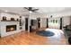 Bright living room with a brick fireplace, ceiling fans, hardwood floors and a large window at 1218 Donna Dr, Shelby, NC 28152
