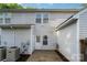 View of the home's back exterior with a patio and white siding at 12925 Windy Lea Ln, Huntersville, NC 28078