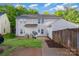 View of the home's back exterior with a grassy area and privacy fence at 12925 Windy Lea Ln, Huntersville, NC 28078