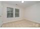 Bedroom features neutral carpet and double windows offering plenty of natural light at 12925 Windy Lea Ln, Huntersville, NC 28078