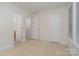 Bright bedroom features carpet, multiple closets, and bathroom access at 12925 Windy Lea Ln, Huntersville, NC 28078