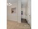 Bright dining room with carpet, view to kitchen, and access to front hallway at 12925 Windy Lea Ln, Huntersville, NC 28078