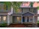 Charming two-story townhome with covered front porch and neutral siding at dusk at 12925 Windy Lea Ln, Huntersville, NC 28078