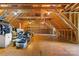 Unfinished attic space with exposed rafters, wooden flooring, and shelving at 1441 Carmel Rd, Charlotte, NC 28226