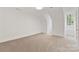 Large attic room with white walls, carpet, and a large window at 1441 Carmel Rd, Charlotte, NC 28226