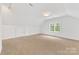Finished attic room with neutral carpet, recessed lighting, and a window at 1441 Carmel Rd, Charlotte, NC 28226